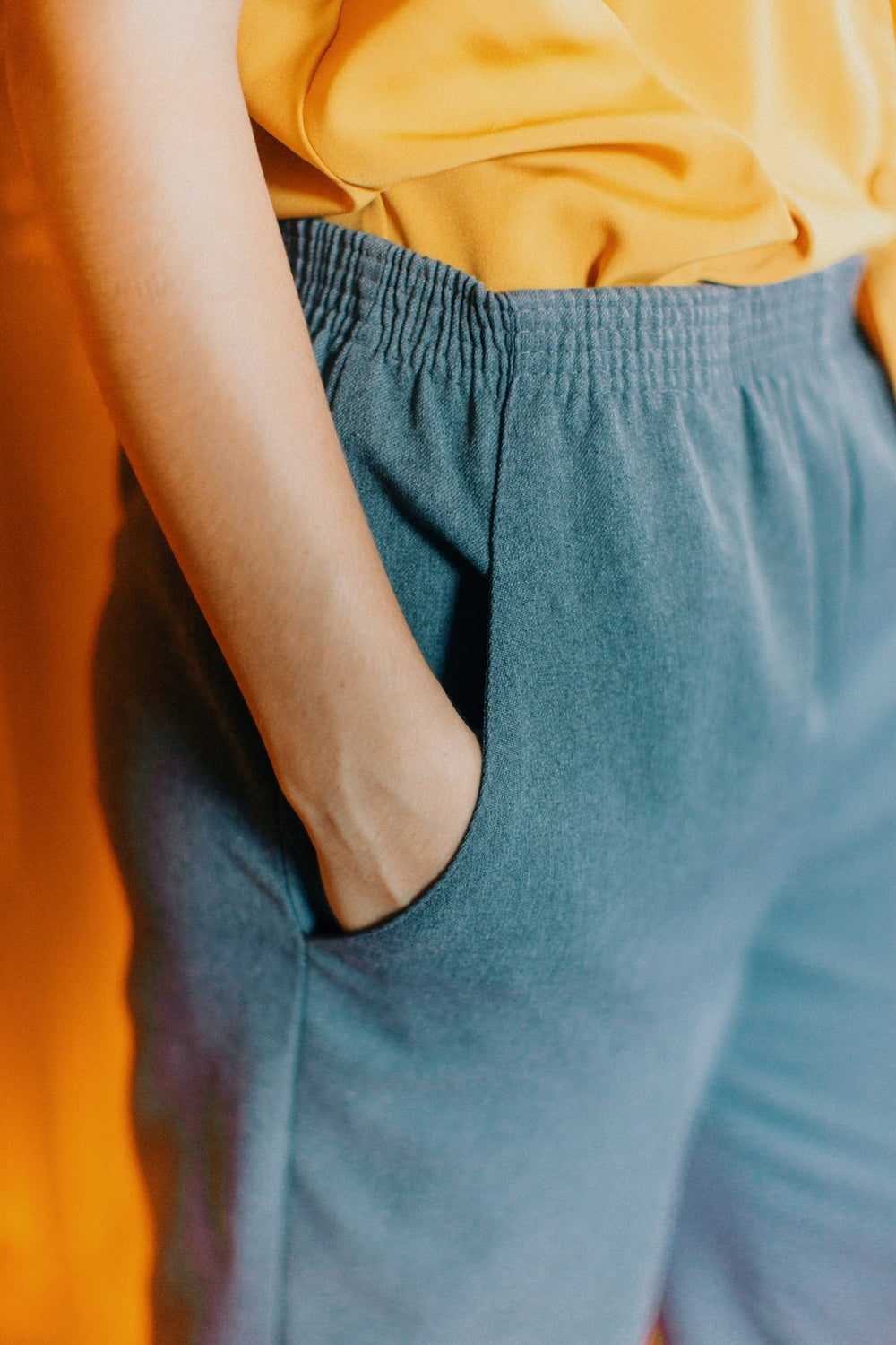 Woman wearing high-waisted contour shorts, back view showing sculpting seam.